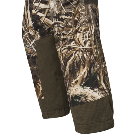 Pantalon de chasse Beretta Tri-Active EVO imperméable avec motif Camo Raltree Max5, offrant un tissu silencieux et respirant pour une grande liberté de mouvement grâce à ses inserts élastiques, idéal pour les espaces ouverts et les chasseurs exigeants.