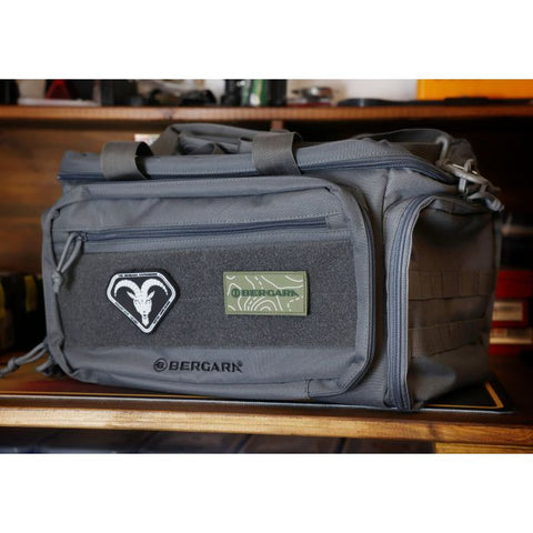 Sac de tir Bergara en polyester gris avec multiples compartiments amovibles, poches zippées et sangles MOLLE, idéal pour armes de poing, chargeurs, et accessoires de tir sportif. Dimensions 43 x 28 x 26 cm, volume 20 litres, avec porte-cartes transparent et double poignée pour transport sécurisé