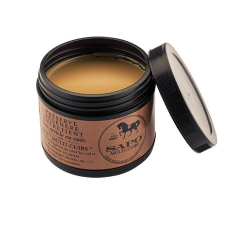 Produit pour entretien du cuir lisse, lanoline, huile d'avocat et cire d'abeille, idéal pour selles, brides, harnais, chaussures et vêtements en cuir, disponible en 100 ml ou 500 ml avec options brosse, parfumé au miel pour nourrir et assouplir le cuir.