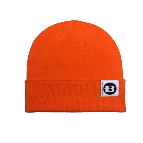 Bonnet Bergara Adak en acrylique et élasthanne, certifié OEKO-TEX, couleur vert et orange pour haute visibilité. Idéal pour chasse et outdoor, offrant protection contre froid et vent grâce à son tissu respirant et ses techniques de teinture écologique. Taille 24x21 cm avec revers 7 cm, lavable en machine.